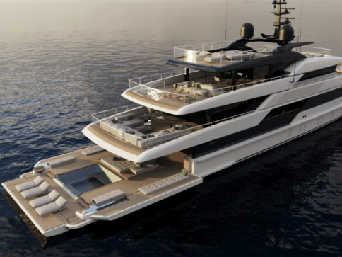 A luxurious, modern multi-deck yacht with sun loungers, open seating areas, and a small pool at the stern, anchored on calm water at sunset.