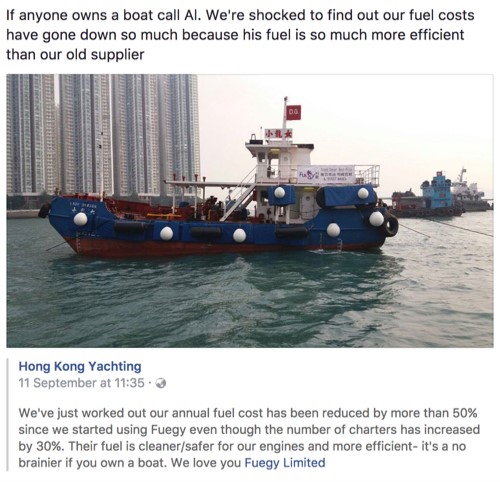 A small yacht floats in a harbour in front of tall city buildings. The vessel has a white cabin, blue fenders, and people on deck. Text above discusses reduced fuel costs thanks to a new, more efficient fuel supplier.