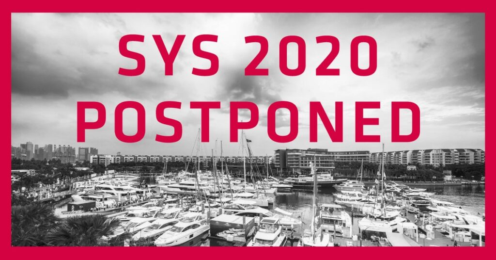 Black and white photo of a marina filled with boats, with large pink text overlaid that reads SYS 2020 POSTPONED. A red border frames the image.
