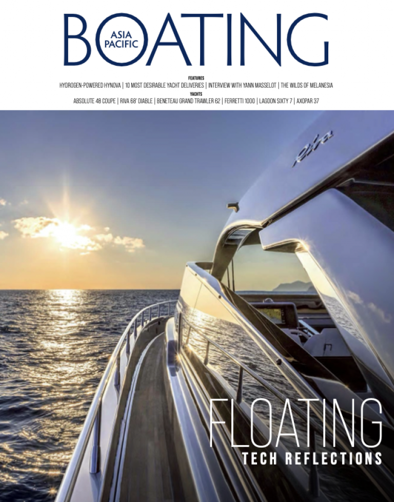 A glossy yacht cruises on calm water at sunset, reflecting the golden sunlight and blue sky on its sleek surface. The magazine cover reads Asia Pacific Boating with the headline Floating Tech Reflections.