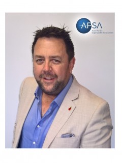 A man in a beige blazer and blue shirt smiles at the camera. The APSA (Asia Pacific Superyacht Association) logo appears in the top right corner on a white background.