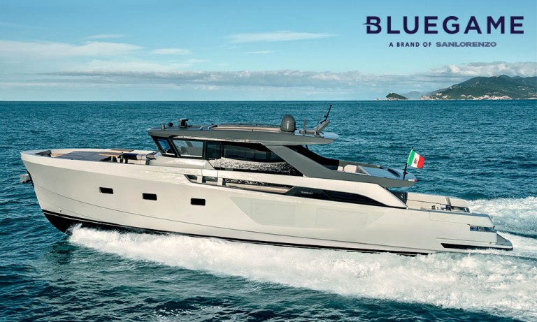 A modern luxury yacht cruising on the sea with an Italian flag, viewed from the side; the BLUEGAME logo appears in the top right corner against a clear blue sky.