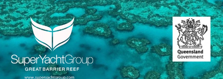 Aerial view of coral reefs in turquoise water with the Super Yacht Group Great Barrier Reef logo at left, the Queensland Government crest and name at right, and the website www.superyachtgroup.com at the bottom.