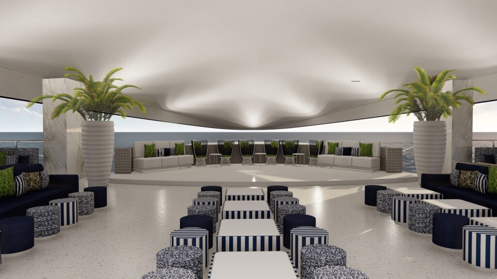 A spacious, modern lounge with striped seating, large potted plants, and floor-to-ceiling windows overlooking the sea. White walls and ceiling create a bright, airy atmosphere.