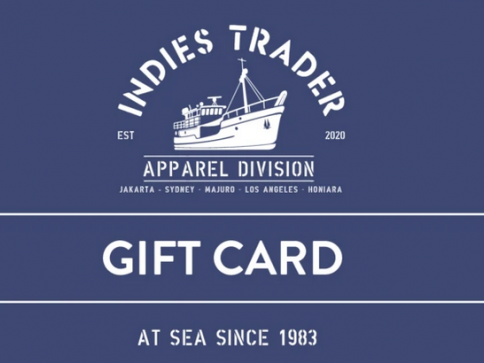 Dark blue gift card featuring a white illustration of a fishing boat with the text Indies Trader Apparel Division, city names, Gift Card, and At sea since 1983 in capital letters.