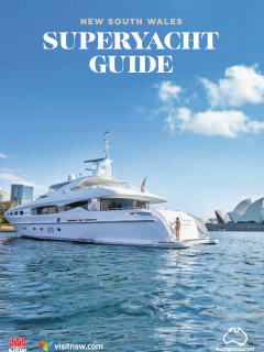 A large white superyacht is moored in Sydney Harbour with the Sydney Opera House and city skyline in the background under a clear blue sky. Text reads: New South Wales Superyacht Guide.