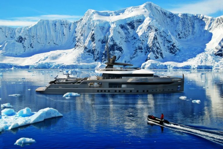 A luxury yacht is anchored in icy blue water surrounded by floating ice and snow-covered mountains, with a small motorboat carrying people speeding in the foreground.
