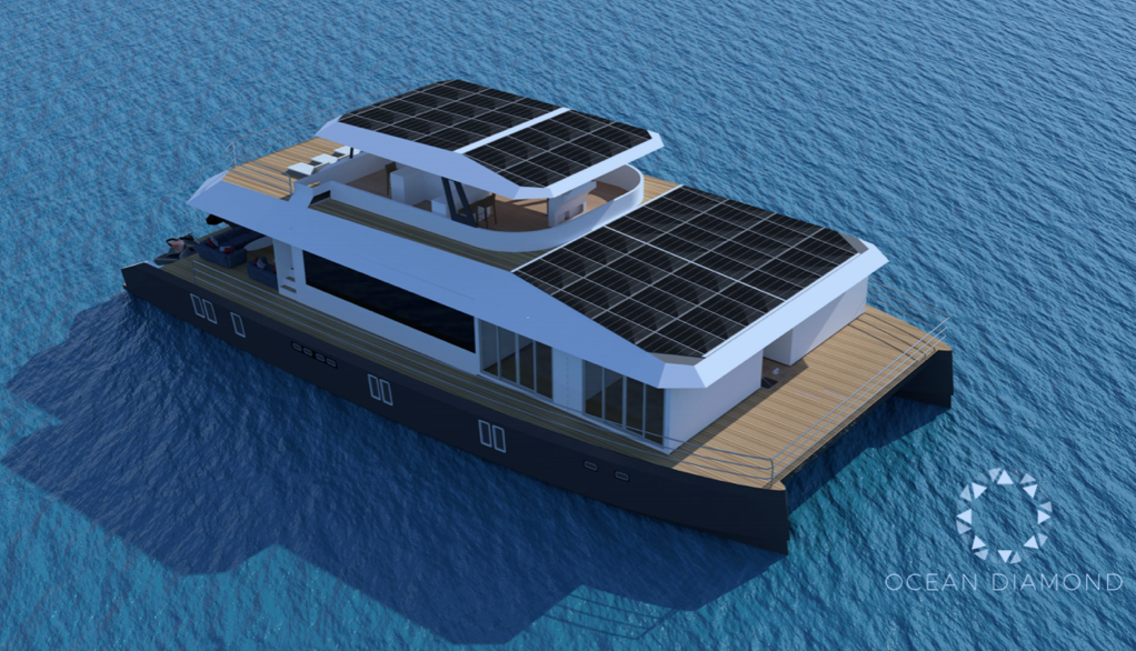 A modern catamaran yacht with large solar panels on the roof floats on calm blue water. The yacht has two decks and a sleek design, with the Ocean Diamond logo visible in the lower right corner.