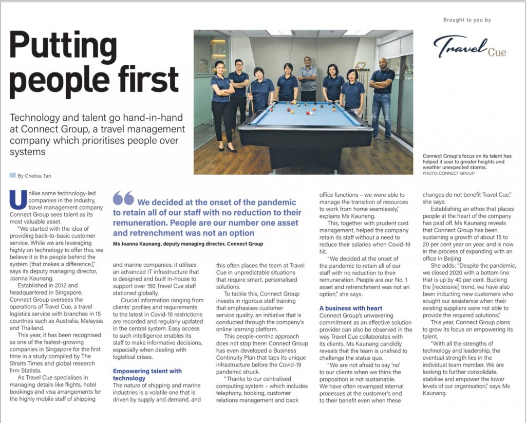 A magazine article titled Putting people first features a photo of nine people standing around a blue pool table in an office. The article discusses Connect Group’s focus on talent in travel management. Travel Cue’s logo appears in the top right corner.