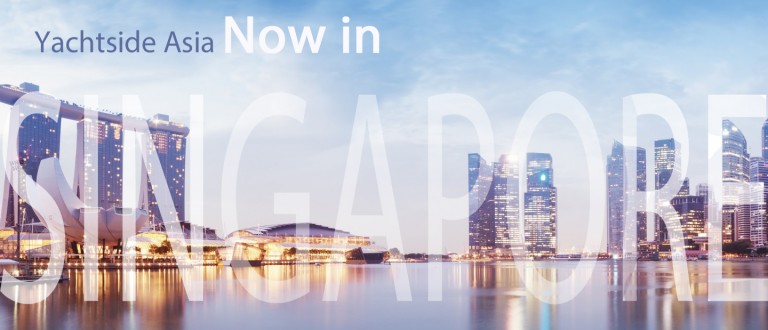 A cityscape of Singapore at dusk with illuminated skyscrapers and water reflections. Overlaid text reads “Yachtside Asia Now in SINGAPORE”.