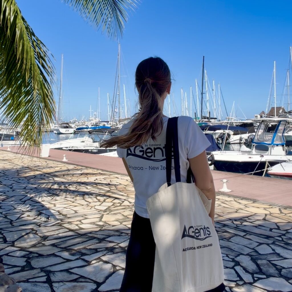 Catalano Agents team member at Marina de Papeete, Tahiti, with fleet of yachts in background
