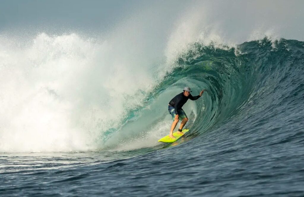 Surfer riding a barrelling wave in Indonesia