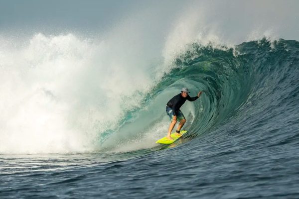 Surfer riding a barrelling wave in Indonesia